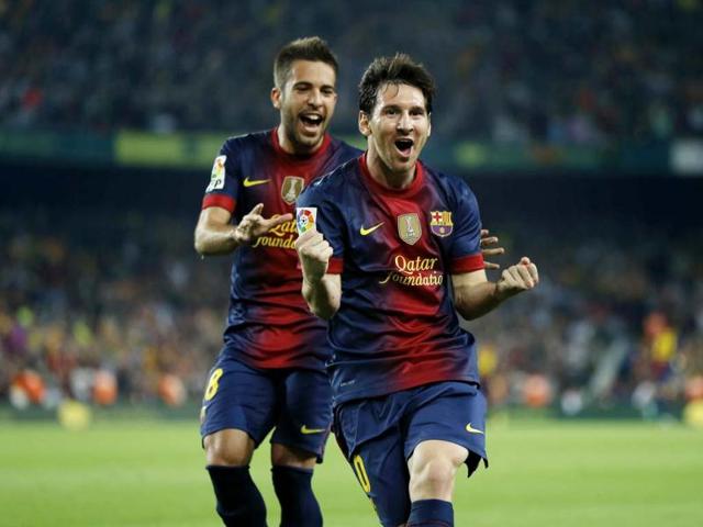 Barcelona's Lionel Messi from Argentina, right, celebrates after scoring a goal against Real Madrid's during a Spanish La Liga soccer match at the Camp Nou Stadium, in Barcelona. (AP Photo)