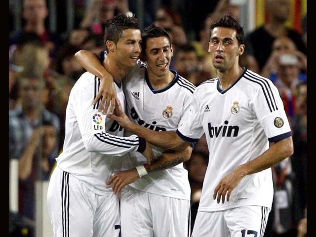 Real Madrid's Cristiano Ronaldo celebrates with teammates Angel di Maria and Alvaro Arbeloa after scoring against Barcelona during their Spanish first division soccer match at Nou Camp stadium in Barcelona. (Reuters)