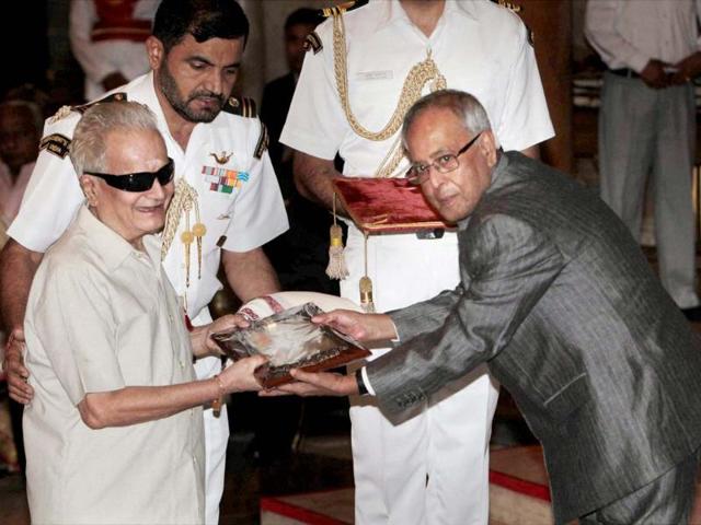 President Pranab Mukherjee presenting fellowship of Sangeet Natak Akademi to Violin maestro Mohan Chandrasekaran during the Sangeet Natak Akademi Awards 2011 function at Rashtrapati Bhavan in New Delhi . PTI Photo by Subhav Shukla