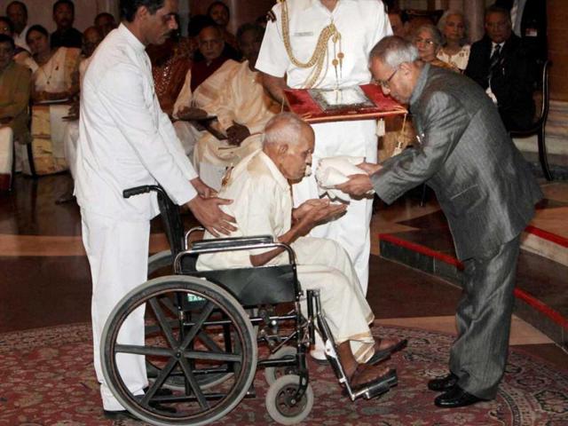 President Pranab Mukherjee presenting Akademi award to leading master of 'panchari melam', Thrippekulam Achutha Marar of Kerala during the Sangeet Natak Akademi Awards 2011 function at Rashtrapati Bhavan in New Delhi. PTI/Subhav Shukla