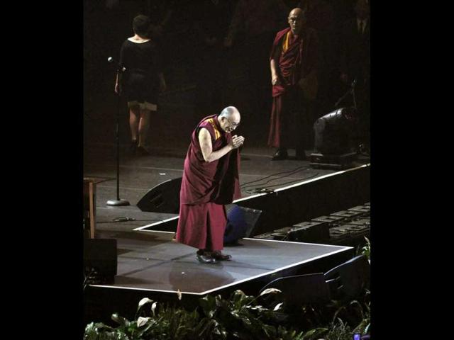 The Dalai Lama acknowledges the audience during the One World concert as part of the Common Ground for Peace two-day forum in Syracuse, N.Y. AP/Kevin Rivoli
