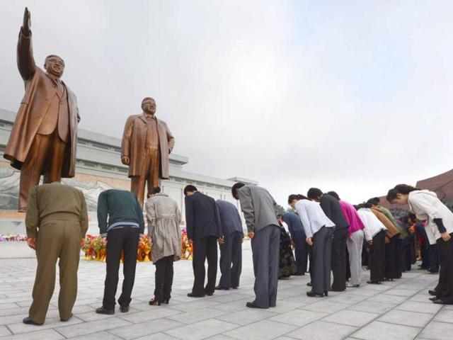North Koreans bow in front of the statues of the country's founding ruler Kim Il Sung, left, and his son and successor Kim Jong Il to mark the 67th founding anniversary of the ruling Workers' Party of Korea, in Pyongyang, North Korea. AP/Kyodo News