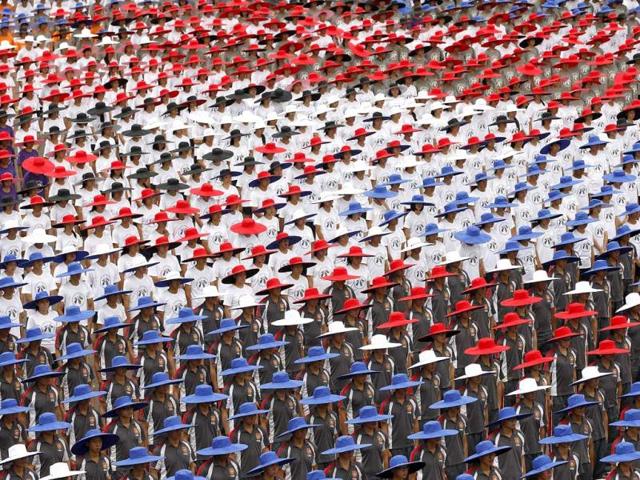People wearing hats in the colours of Taiwan's national flag take part in the country's National Day celebrations in front of the Presidential office in Taipei. Reuters/Pichi Chuang