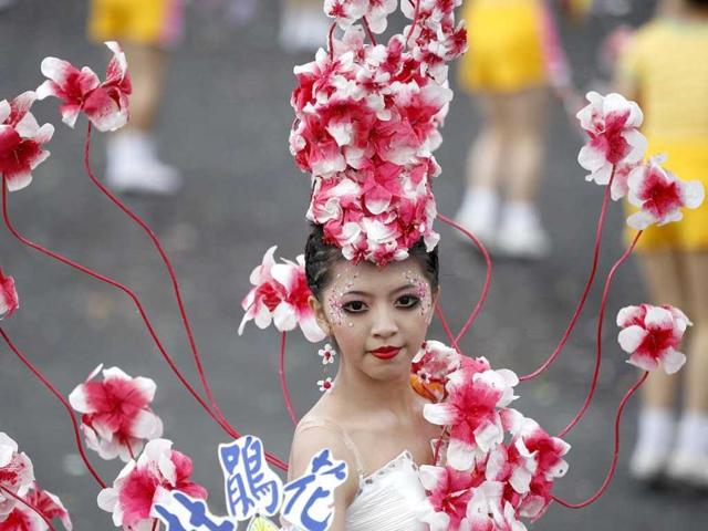 A dancer adorned with flowers performs during Taiwan's National Day celebrations in front of the Presidential Office in Taipei. This year marks the 101st anniversary of the founding of the Republic of China. The Chinese characters read, "Azalea". Reuters/Pichi Chuang