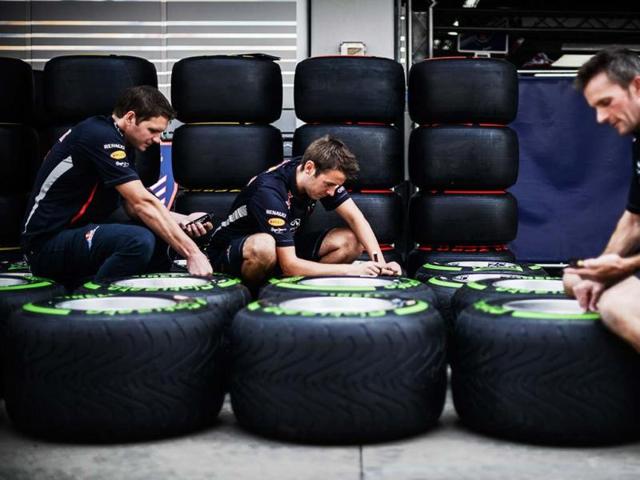 Red Bull team members check tyres in the pit lane of the circuit for the Formula One Korean Grand Prix in Yeongam. AFP photo