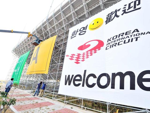 South Korean workers attach a banner to the backside of the grandstands at the Korean Circuit in Yeongam. AFP photo
