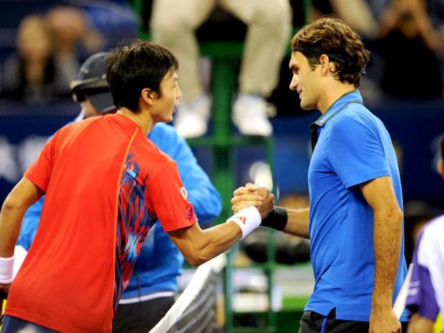 Roger Federer of Switzerland shakes hands with Yen-Hsun Lu of Taiwan after beating him in their second round match of the Shanghai Masters tennis tournament in Shanghai. AFP/Peter Parks