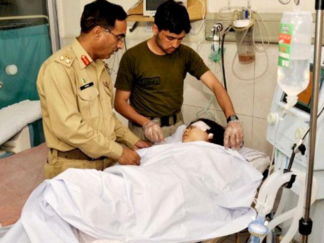 Pakistani army doctors give treatment to injured Malala Yousafzai, 14, at an army hospital following an attack by gunmen in Peshawar AFP