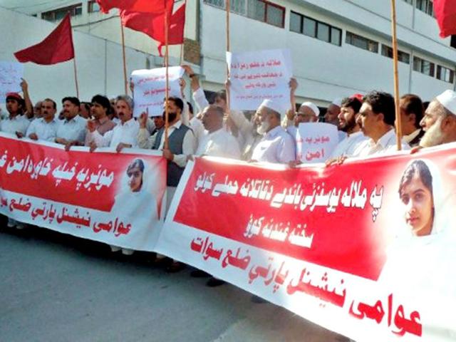 Pakistani activists of Awami National Party carry banners as they march during a protest against the assassination attempt on a girl Malala Yousafzai, in Mingora, the main town of the Swat valley AFP / Mohammad Rehman