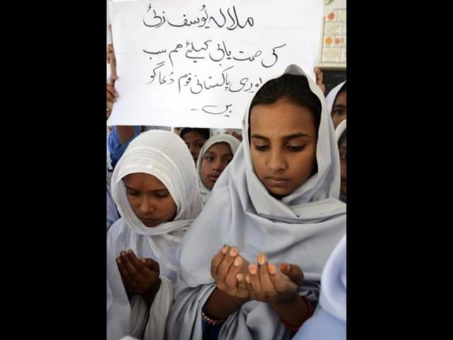 Pakistani school girls pray for the recovery of gunshot victim, Malala Yousafzai, in Multan. AFP / SS Mirza