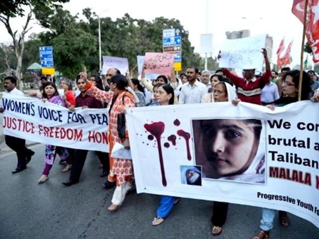 Pakistani civil society activists carry banners as they shout ant-Taliban slogans during a protest rally against the assassination attempt on Malala Yousafzai, in Islamabad AFP /Aamir Qureshi