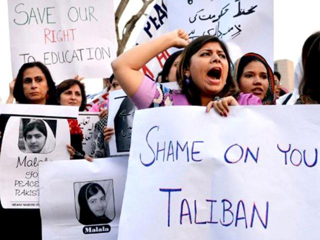 Pakistani civil society activists carry placards with a photograph of the gunshot victim Malala Yousafzai during a protest rally against the assassination attempt on Malala Yousafzai, in Islamabad. AFP / Aamir Qureshi