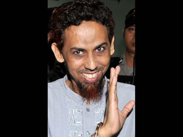 A file photo of convicted Indonesian Islamist Umar Patek gesturing towards journalists after his trial in Jakarta. AFP Photo