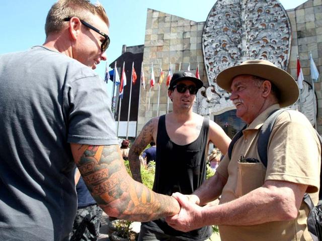 Spike Stewart, right, who lost his son during the 2002 Bali bombings greets a friend at the Bali memorial monument in Kuta, Bali. AP Photo