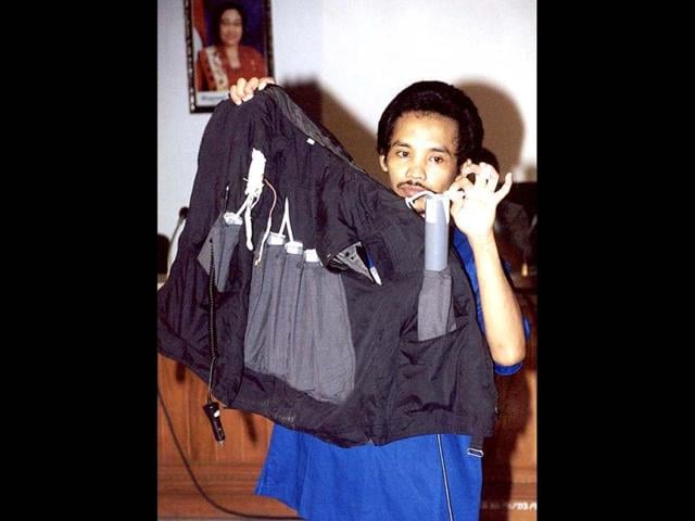 A file photo showing convicted Indonesian Bali bomber Ali Imron displaying a vest with mock bombs as part of the police reconstruction on how the suicide bomber wore the explosive, during the investigation in Denpasar on Bali island. AFP Photo