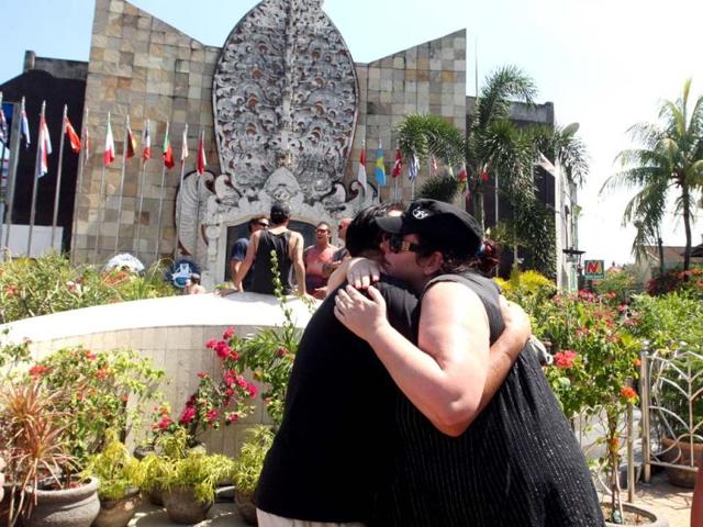 Australian survivors of 2002 Bali bombings hug each other in front of the Bali memorial monument as they pay their respect to victims who were killed in the nightclub bombings in Kuta, Bali. AP Photo
