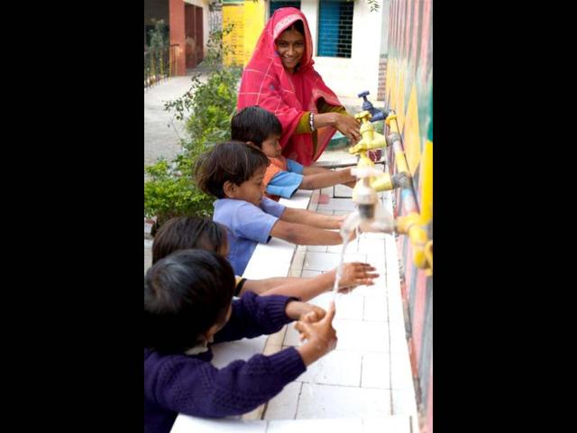 Washing hands with soap, particularly after contact with excreta and before handling food, can reduce diarrhoeal diseases by over 40% and respiratory infections by 30%. Smarika, a teacher at the Khanjadipur primary school and anganwadi centre, demonstrates good handwashing practice to anganwadi children in UP. Photo courtesy: Unicef