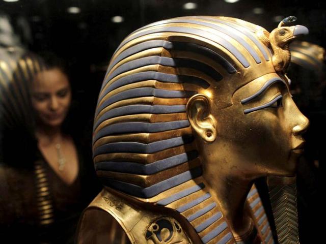 An employee looks at a replica of the golden death mask of Egyptian pharaoh Tutankhamun at the King Tutankhamun Exhibition in the Reina Torre de Arauz museum in Panama City. Reuters photo
