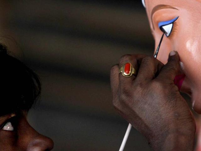 An artist paints eyes of goddess Durga idol for Durga puja festival at Mayur Vihar phase II in New Delhi. HT photo/Arijit Sen