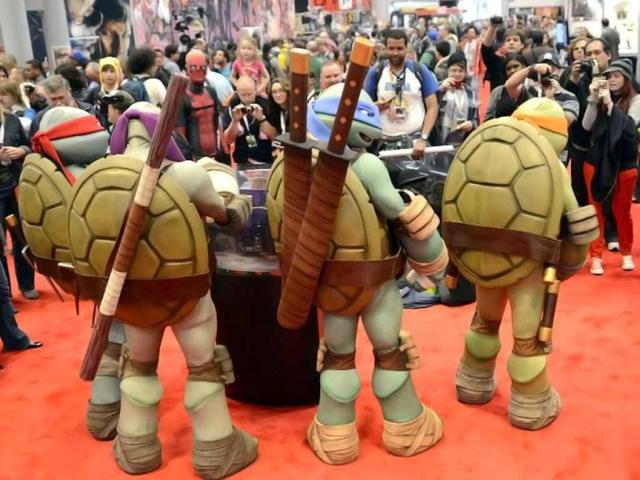 Mutant Ninja Turtles pose for photos as fans in costume arrive for the opening session of the 2012 New York Comic Con at the Jacob Javits Center. AFP / Timothy A. Clary