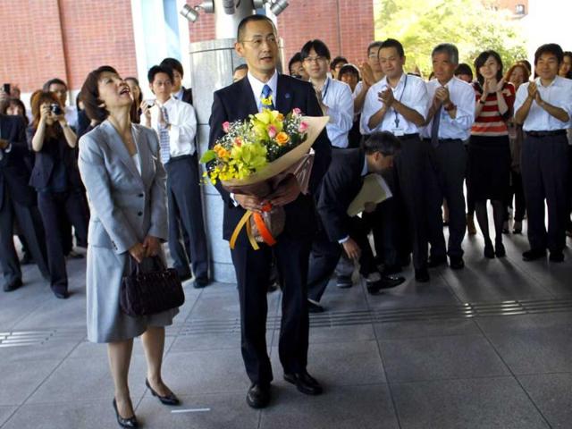 Nobel prize laureate in medicine Shinya Yamanaka of Japan and his wife Chika arrive at Kyoto University for a press conference in Kyoto, western Japan. AP/Junji Kurokawa