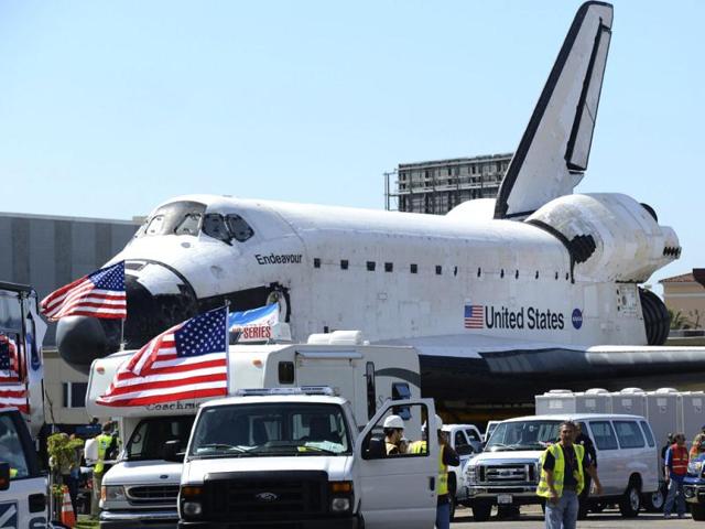 Space shuttle Endeavour makes its way from Westchester square to Randy's Donuts during its final ground journey in Los Angeles, California. Endeavour nosed out of Los Angeles International Airport as it began a two-day journey at 2 miles per hour (3.2 km per hour) atop a massive wheeled transporter to its retirement home at the California Science Center on the edge of Los Angeles downtown. Reuters photo