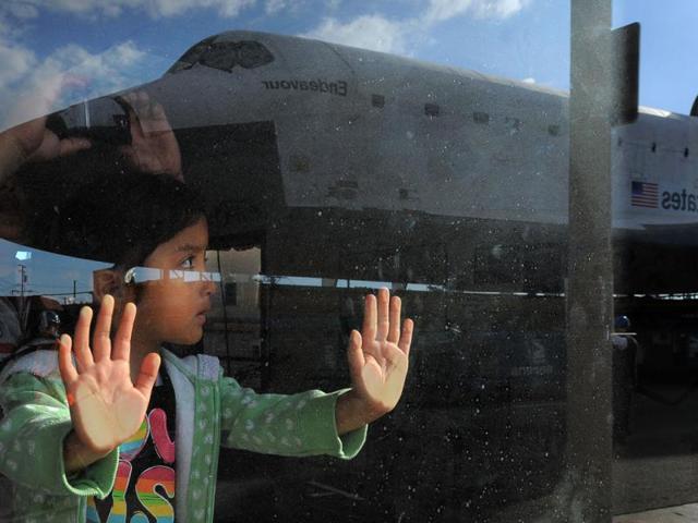 Space shuttle Endeavour is seen reflected in a window on route from Westchester square to Randy's Donuts during its final ground journey in Los Angeles. AP photo
