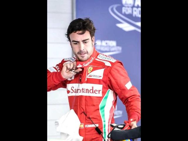 Ferrari driver Fernando Alonso of Spain looks down after finishing fourth in the qualifying session of the Formula One Korean Grand Prix in Yeongam. AFP / Philippe Lopez