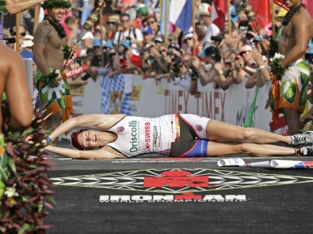 Leanda Cave, of Britain, rolls across the finish line as the women's winner of the Ironman World Championship triathlon in Kailua-Kona, Hawaii. AP/Chris Stewart