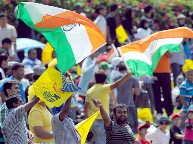 Cricket fans wave flags during a Group B match of the Champions League T20 between the Chennal Super Kings and the Sydney Sixers at the Wanderers Stadium in Johannesburg. AFP photo