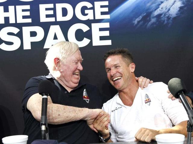 Felix Baumgartner shares a laugh with Col Joe Kittinger, USAF retired, after successfully jumping from a space capsule lifted by a helium balloon at a height of just over 128,000 feet above the Earth's surface, beating Kittinger's old record of 102,799 ft. AP/Ross D Franklin