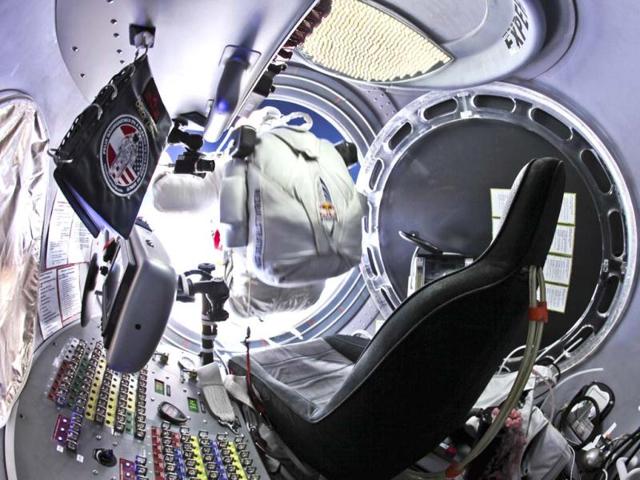 This photo provided by Red Bull Stratos shows pilot Felix Baumgartner, of Austria, preparing to jump from the capsule during the final manned flight for Red Bull Stratos. In a giant leap from more than 24 miles up, Baumgartner shattered the sound barrier Sunday while making the highest jump ever — a tumbling, death-defying plunge from a balloon to a safe landing in the New Mexico desert. AP/Red Bull Stratos, Jay Nemeth