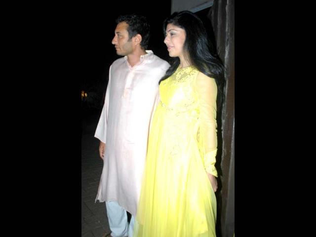 Fashion editor Anaita Shroff, in a yellow anarkali, poses with her husband Homi Adajania. (Photo credit: Prodip Guha)