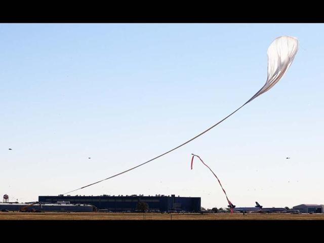 The capsule and attached helium balloon carrying Felix Baumgartner begins to lift off as he attempts to break the speed of sound. AP/Ross D Franklin