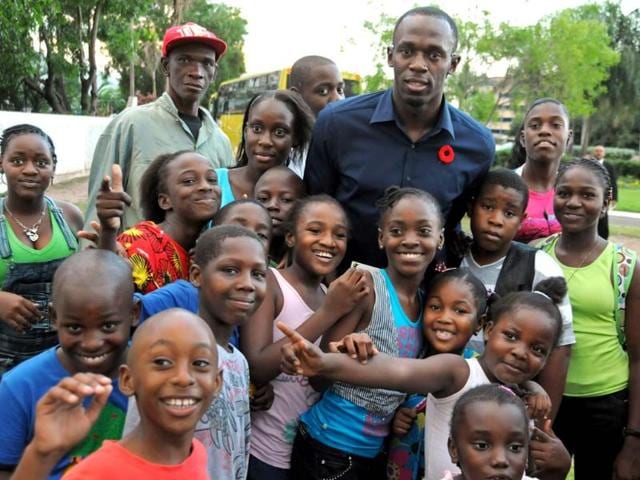 Olympic sprinting champion Usain Bolt poses for a photo with children while attending the annual national awards ceremony on National Heroes Day in Kingston, Jamaica. AP/Collin Reid