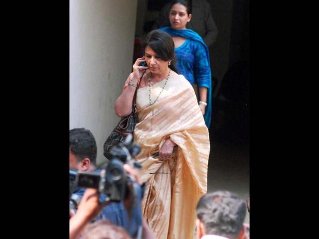 Sharmila Tagore speaks on phone as cameramen click her. HT Photo/Prodip Guha