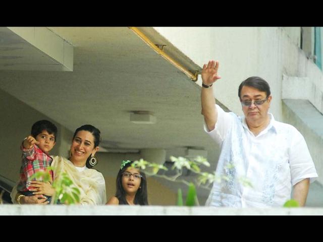 Karisma Kapoor, her kids and Randhir Kapoor wave at the media. HT Photo/Prodip Guha