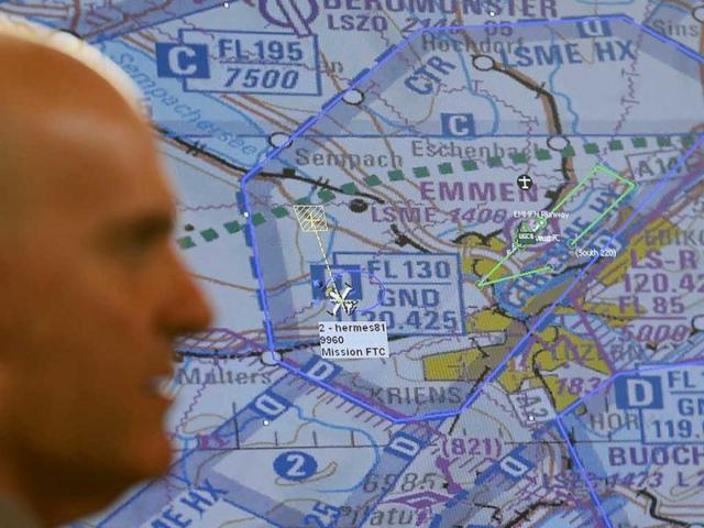 A man observes an Israeli Elbit Systems Ltd. Hermes 900 unmanned aerial vehicle (UAV) on a screen during a media presentation over the airbase in the central Swiss town of Emmen. Reuters/Pascal Lauener