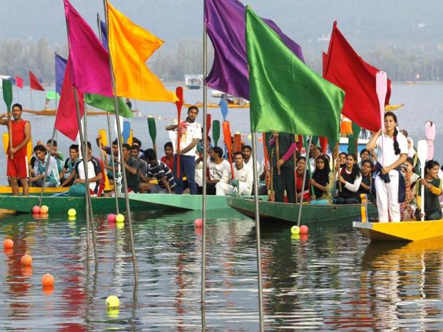 Participants hold up their paddles during the opening ceremony of "Jashan-e-Dal" in Dal Lake in Srinagar. Reuters photo