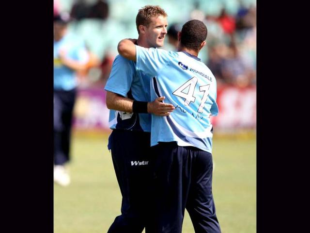 Michale Bates (L) and Andre Adams celebrate a wicket during the Champions League T20 (CLT20) cricket match between the Nashua Titans (South Africa) and the Auckland Aces (New Zealand) at the Sahara Park Kingsmead in Durban . AFP PHOTO / STR