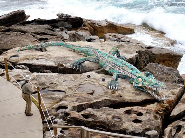 A man looks at a sculpture called 'Ghost Net Crocodile 2011' by remote community indigenous artists at the Sculpture by the Sea exhibition in Sydney. AFP photo
