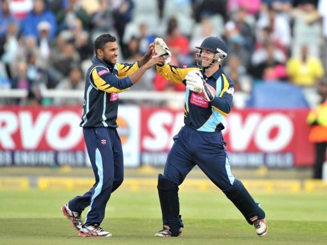 Adil Rashid of Yorkshire Carnegie celebrates with teammate Dan Hodgson after taking the wicket of Rohit Sharma of the Mumbai Indians during Match 11 of The Champions League T20 (CLT20) between the Mumbai Indians (India) and Yorkshire (England) at Newlands Cricket Stadium in Cape Town. AFP Photo/Luigi Bennett