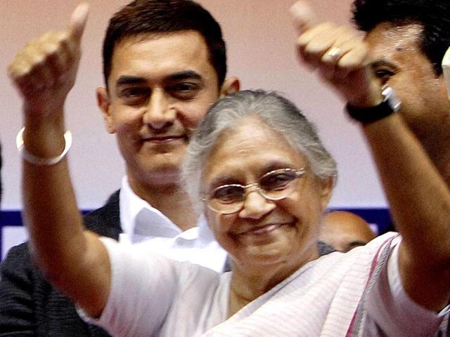 Delhi Chief Minister Sheila Dikshit gestures as actor Aamir Khan looks on at an award function. (PTI Photo)