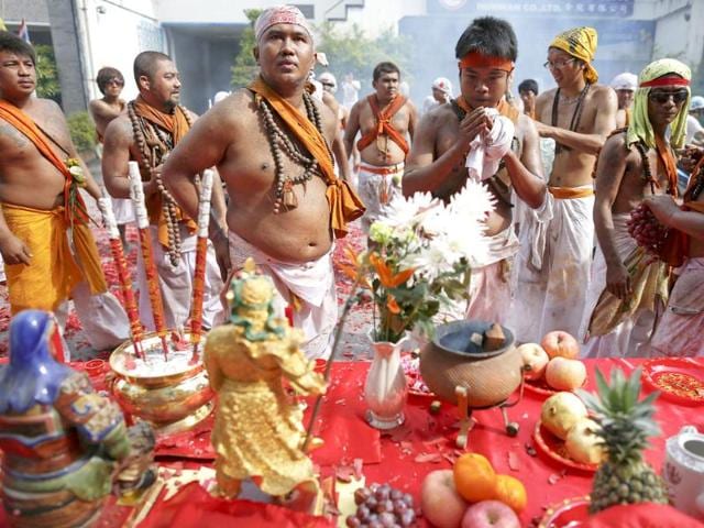 Devotees of Ban Tha Rua Chinese shrine are offered fruits from residents during a procession celebrating the annual vegetarian festival in Phuket. (Reuters/Damir Sagolj)