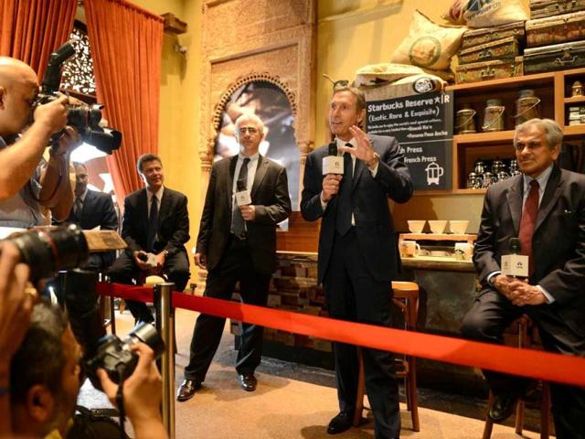 Starbucks Coffee Company's chairman Howard Schultz speaks as vice chairman of Tata Global Beverages RK Krishnakumar watches during a news conference at the country's first newly-inaugurated Starbucks outlet in Mumbai. AFP/Punit Paranjpe
