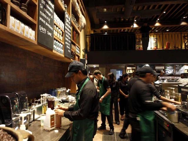 Employees of the newly inaugurated outlet of Starbucks work at a counter in Mumbai. Starbucks inaugurated its first store in India in a building in southern Mumbai as the Seattle-based coffee giant seeks growth in a market long associated with tea drinkers. AP/Rajanish Kakade