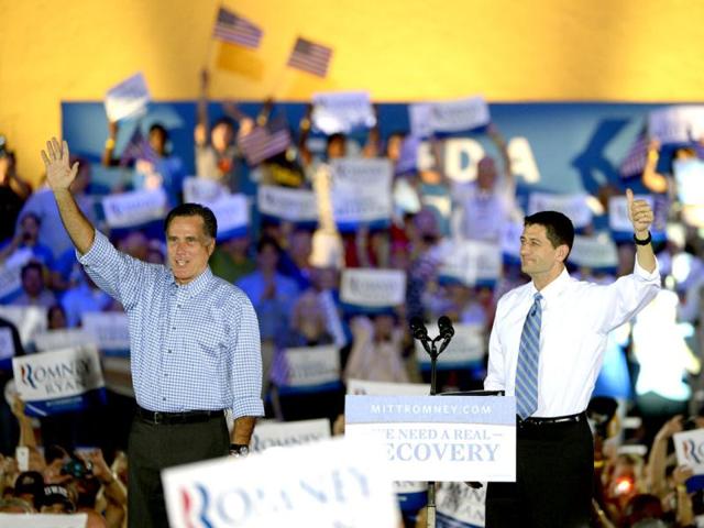 Republican presidential candidate Mitt Romney, left, and his vice presidential running mate Representative Paul Ryan wave to supporters after arriving on stage during the Romney Ryan Victory Rally in Daytona Beach, Florida. AP photo
