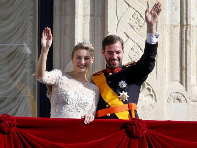 Luxembourg's Prince Guillaume and Countess Stephanie wave from the balcony of the Royal Palace after their wedding in Luxembourg. AP Photo
