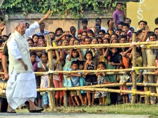 President Pranab Mukherjee waves to the public as he arrives at his ancestral village Mirati to take part in Durga Puja. PTI