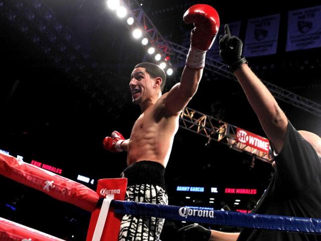 Danny Garcia celebrates after defending his WBC and WBA super lightweight titles against Mexico's Erik Morales during a boxing bout at the Barclays Center in New York. Garcia knocked out Morales in the fourth round. AP photo